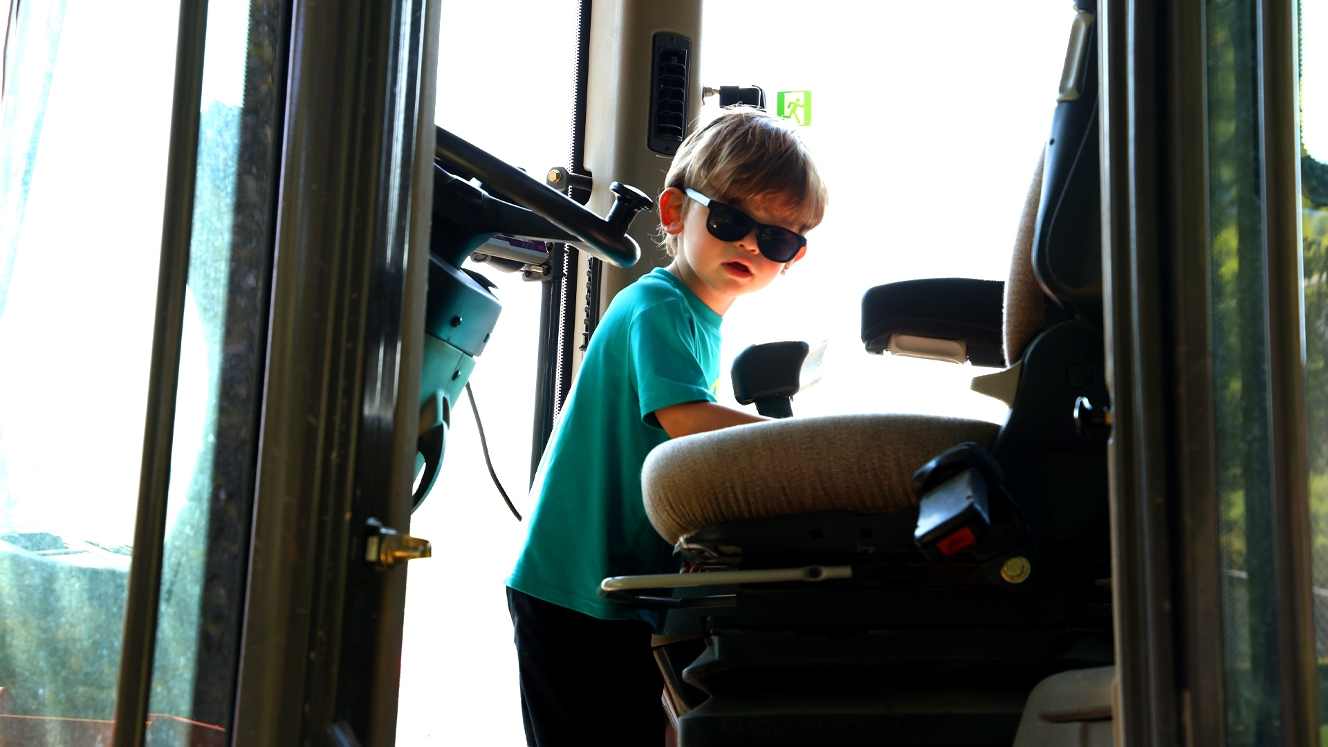 boy child in cab of bulldozer